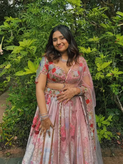 A full-length shot of the bridesmaid, looking fresh and ready for a daytime wedding.