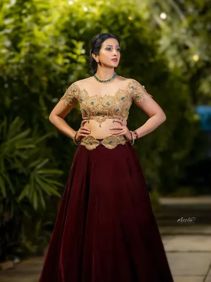 A full-length shot that captures the power and elegance of the entire look. The strong pose and direct gaze make this a very impactful portrait.