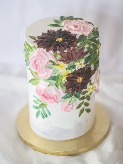 I love playing with moody color palettes. The deep burgundies and pinks against the marbled grey frosting give this tall floral cake a sophisticated and artistic feel, perfect for an elegant celebration.