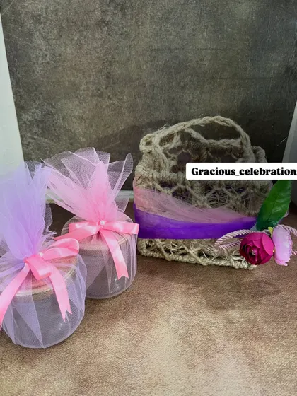 An affordable and cute gifting option. This small jute bag is shown here with two net-wrapped jar candles, but it can be customized for any occasion.