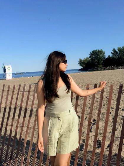 Posing by the fence at the beach, enjoying the last rays of sun.