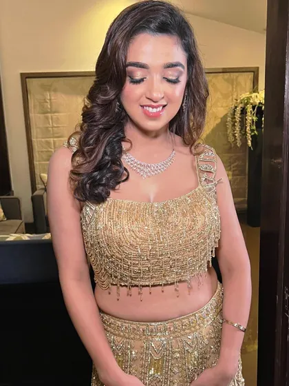 Sangeet ready in a stunning golden lehenga. The makeup is all about that golden hour glow, with shimmery eyes and luminous skin.