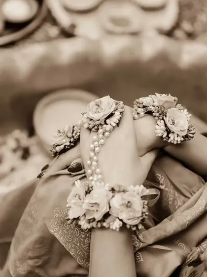 A close-up on the beautiful floral jewellery worn by the bride during her Haldi ceremony. This detail shot highlights the unique and personal touches of the day.