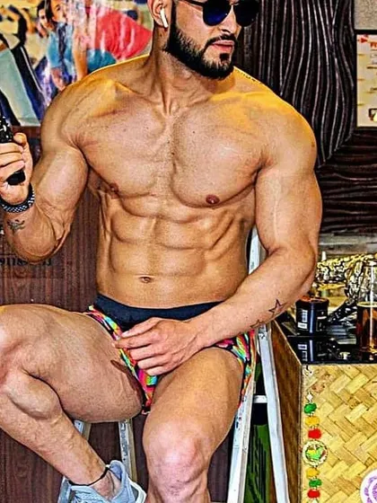 This shot includes some of the tools of the trade in the background, like pre-workout supplements. It's a complete approach to fitness.