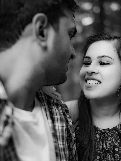 A black and white candid shot from a pre-wedding session in Shimla. This image focuses on the genuine interaction and happy glance between the couple, proving that sometimes the most powerful moments are the simplest ones.