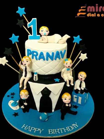 A stylish Boss Baby cake for a first birthday. This two-tier design features multiple baby bosses in suits, creating a fun and sophisticated theme for the little one in charge.