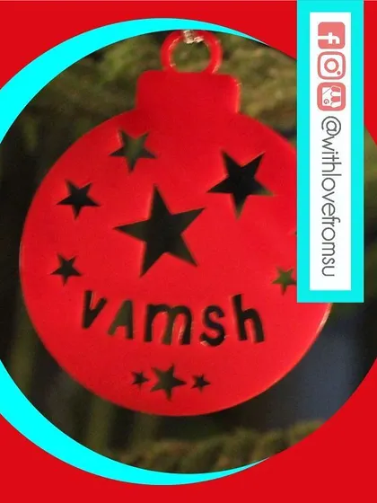 A classic red bauble ornament with a modern twist. The star cutouts and personalized name make it a cheerful and custom addition to your holiday decor.
