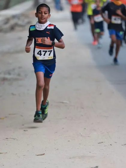 The determination on this young runner's face says it all. Through our training, we focus on proper running form and building stamina, helping kids like him become confident and capable athletes.