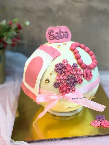 A beautiful pink floral pinata cake for Ramadan, decorated with a tasbeeh and a custom name plaque.