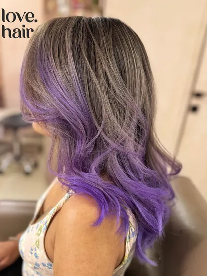 A side view of the ash brown and purple blend, showing how the purple is concentrated on the ends and around the face for a bold, framing effect.