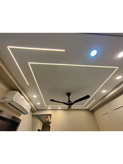A close-up of a geometric false ceiling design with linear LED lights. This is a great way to add a modern, architectural element to any room.