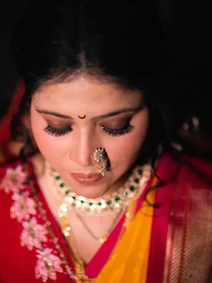 A top-down view highlighting the flawless eyeshadow blend and the traditional crescent moon bindi.