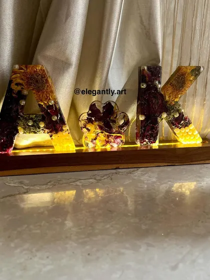 This monogram lamp was made using varmala flowers and includes a cute paw print. It's a wonderful way to include a beloved pet in a wedding keepsake.