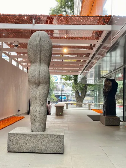 Another view of the Stephen Cox sculptures in the semi-outdoor gallery at MAP. The design uses the building's transparent facade to connect the art inside with the city outside, making the museum a porous and inviting public space.