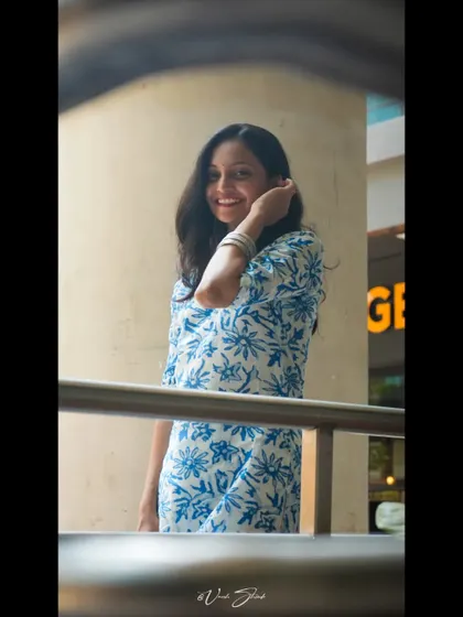 A candid portrait that captures a bright, happy smile. I used a framing technique here to create a sense of peeking into a private, joyful moment.