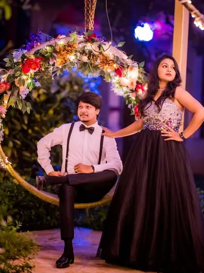 A glamorous nighttime pre-wedding shoot. The client's black sequin ball gown sparkles under the lights, creating a sophisticated and elegant look.