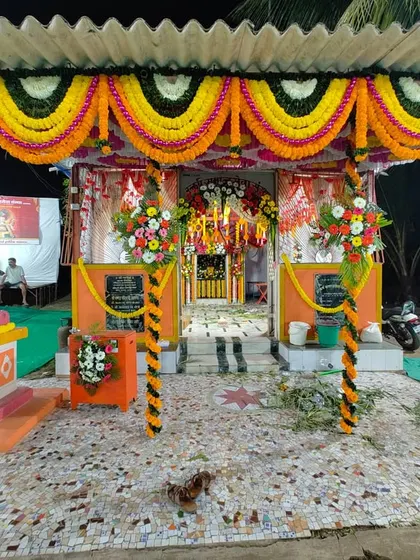Another angle of the Maghi Ganpati pandal decoration in Charkop. The pillars are wrapped in floral garlands, and the entrance is heavily decorated to create a grand welcome for all visitors.