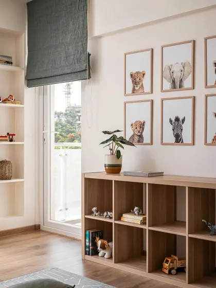 We included plenty of open, accessible storage in the kids' room for toys and books. The gallery wall of sweet baby animal portraits adds a charming and personal touch.