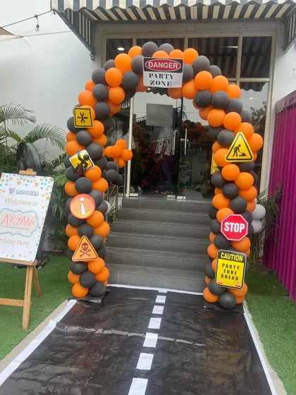 The entrance to our construction-themed party, complete with a balloon arch featuring traffic signs and a custom welcome board.