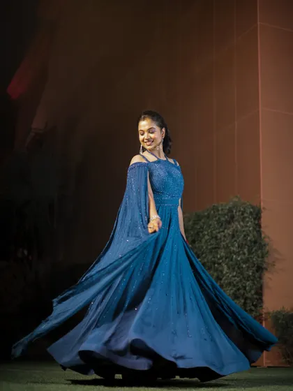 The bride, Somya, twirls in her stunning blue engagement gown. I love capturing these dynamic shots that show off the movement and detail of the outfit.