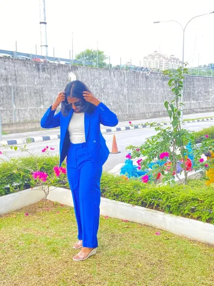A client looking sharp and stylish in a custom-tailored royal blue blazer suit.