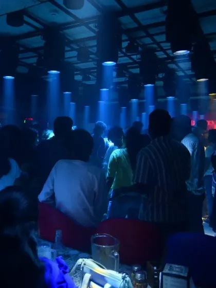 A wide shot of the dance floor during the Hip Hop Tamizha fan party, with the whole room lost in the music.