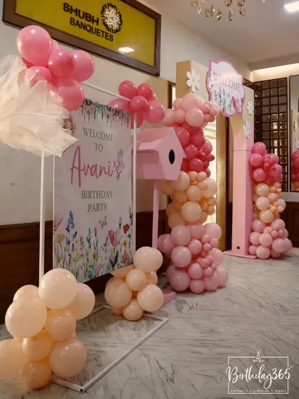 A welcoming entrance to Avani's fairy-themed birthday party, decorated with soft pink balloons and a custom sign.