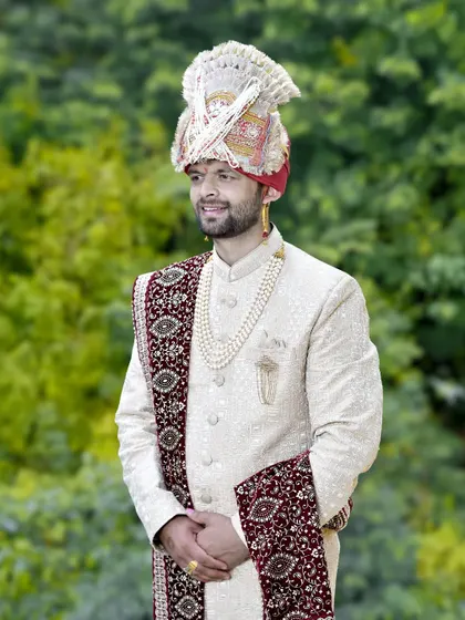 A candid shot of the groom smiling during his outdoor wedding photoshoot. These moments of genuine happiness are what I strive to capture.