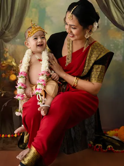 The pure joy of a mother and her little Krishna. This photo from a Janmashtami themed shoot captures a beautiful, candid laugh, celebrating both cultural tradition and a mother's love.