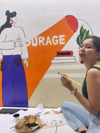 A candid moment while painting the "Courage" section of a corporate values mural. Days filled with color are the best days.