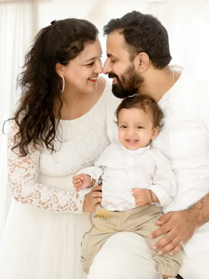 A candid moment of love and laughter between parents while their baby smiles at the camera. These unposed interactions make for the most memorable portraits.