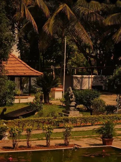 A wide view of our healing retreat, featuring the Goddess Bhuvaneshwari idol, the lotus pond, and lush herbal gardens, all contributing to a transformative wellness experience.