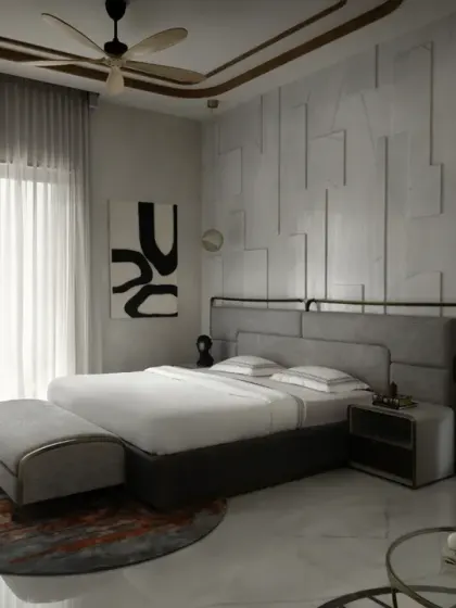 The ground-floor master bedroom in The House of Dancing Screens features contemporary elegance with a textured feature wall and unique artworks. The space is illuminated by natural light from floor-to-ceiling windows.