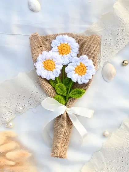 A sweet and innocent bouquet of three handmade crochet daisies. Their cheerful faces are sure to bring a smile to anyone who receives them.