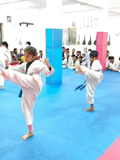 A student practices a high kick.