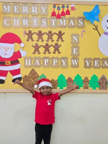 Thumbs up for Christmas fun. This little Aster is full of excitement during our Christmas party, surrounded by festive decorations he helped create.