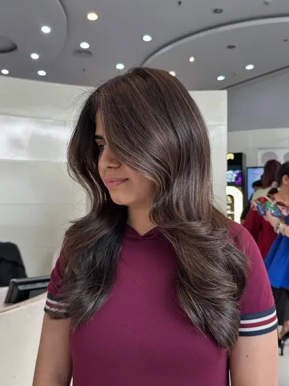A final shot of the cappuccino brown style, showing the beautiful volume and how the side-swept layers frame her face perfectly.