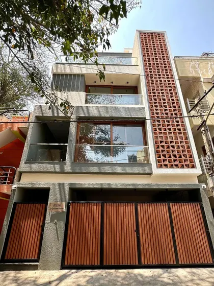 The daytime view of our compact 4BHK residence in a dense South Bengaluru neighborhood, designed to maximize space and natural light on a 750 sqft plot.