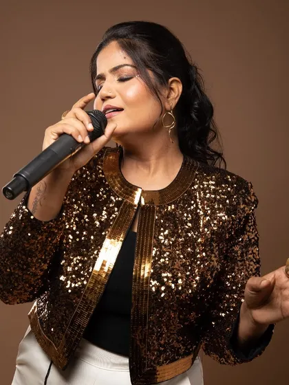 A glamorous look for the photoshoot, featuring a gold sequin jacket and bold, confident makeup.