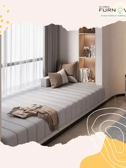 This image highlights a cozy daybed set by a large window, creating a perfect nook for reading or relaxing. The neutral tones and soft textiles enhance the feeling of comfort.