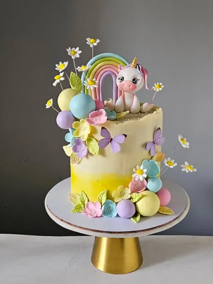 A magical unicorn cake bursting with pastel rainbows, delicate florals, and playful butterflies. This enchanting design is perfect for turning any celebration into a fairytale.