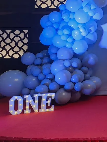 A light-up 'ONE' sign, perfect for a first birthday, seen here at the hot air balloon themed party.