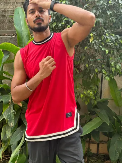 A dynamic pose that shows off the fit of the athletic top and my physique.