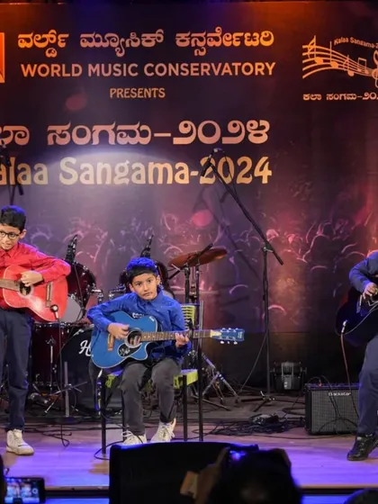 The full trio of young guitarists during their heartfelt instrumental tribute on stage.