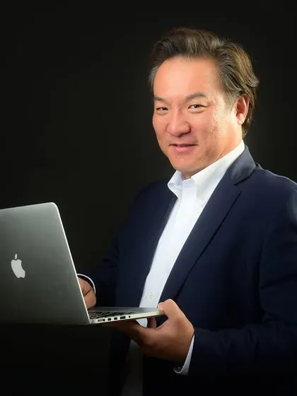A classic corporate headshot against a dark background. This style is timeless and focuses entirely on the subject, conveying professionalism and expertise, perfect for a tech executive.