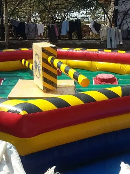 This is our Eliminator inflatable game. It's a competitive obstacle course where players have to jump and duck rotating arms, perfect for bringing high energy to corporate offsites or large parties.