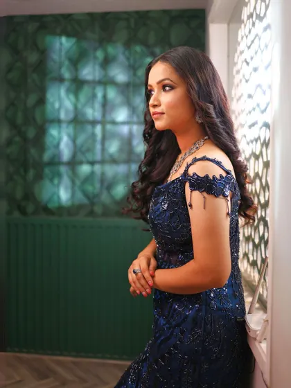 A portrait in our royal blue fish-cut gown, showing the delicate off-shoulder detail.