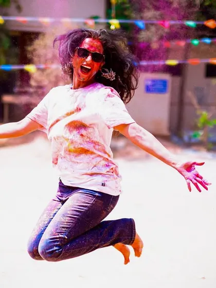 The pure exhilaration of a Holi dance party, captured mid-jump. My goal is to get everyone moving, laughing, and having the time of their lives.