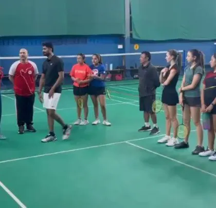 Our coaches interacting with the Peruvian national team, discussing training techniques and strategies. This global partnership enriches our program.