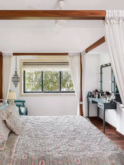 For Aditi Rao Hydari's home, the bedroom is a serene escape. A four-poster bed with light, airy curtains creates a dreamy focal point. The space is kept simple and elegant, with a focus on comfort and tranquility.